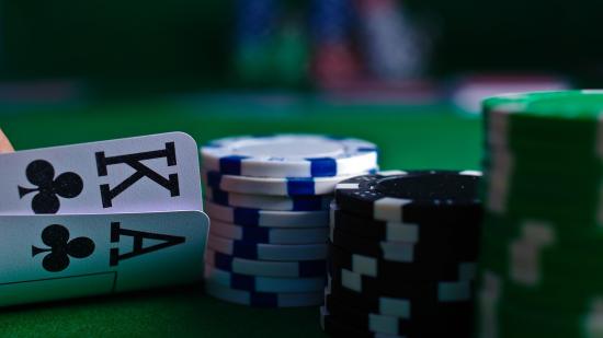 An example of an Omaha Poker showdown - two hands of four hole cards presented alongside five community cards. Photograph by Migg, via Wikimedia